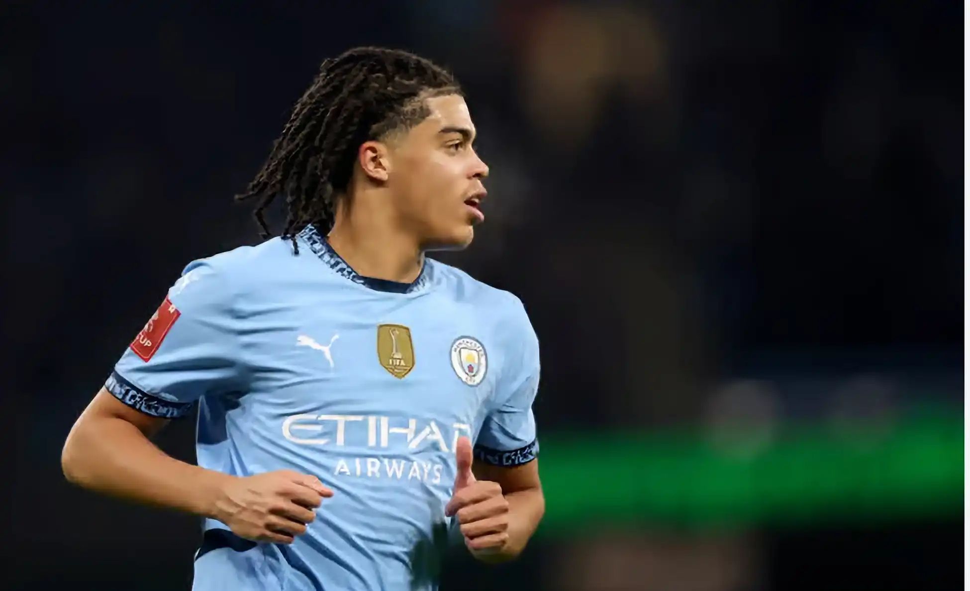 Jahmai Simpson-Pusey in Manchester City kit during a match.