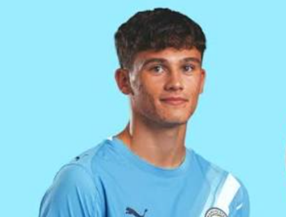 Isaac Smith in Manchester City academy kit, with the club badge visible